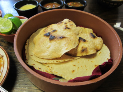 Birria comes with a basket full of soft and toasted tortillas